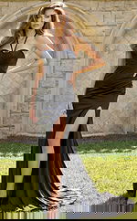 Elegant fitted gown featuring ruched bodice, open back with crisscross straps, and flowing skirt