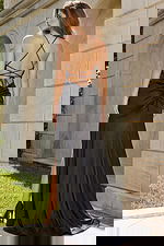 Long fitted gown with gathered waist detail, open strappy back, and sleek silhouette