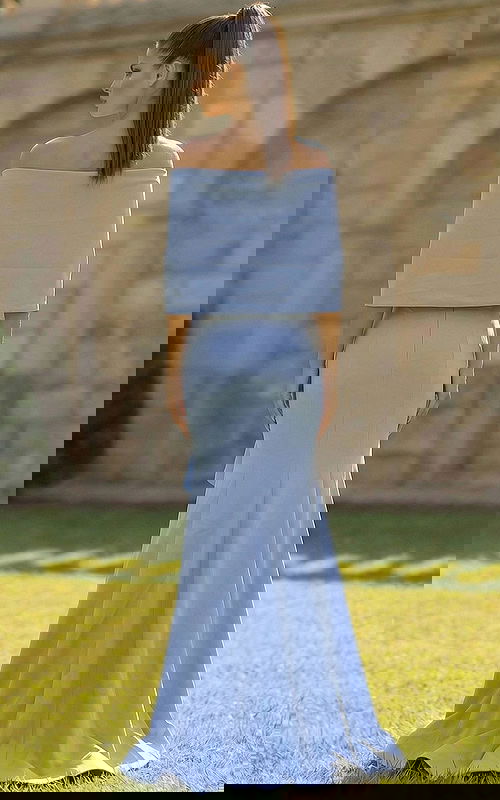 Back view of off shoulder gown with smooth fitted skirt and flared hem