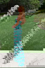 Beaded floral prom gown featuring delicate straps and high slit