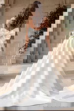 Elegant wedding dress with bow detail and flowing skirt