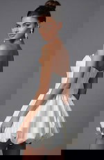 Back view of strapless corset dress featuring fitted waist and gathered bubble skirt