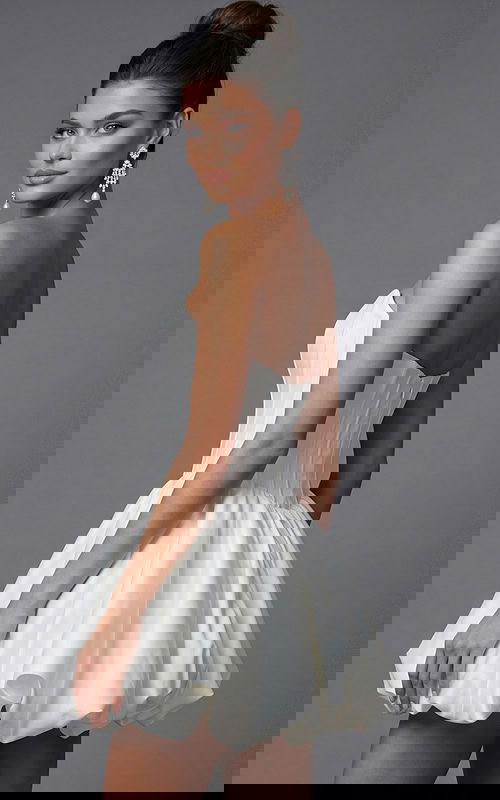 Back view of strapless corset dress featuring fitted waist and gathered bubble skirt