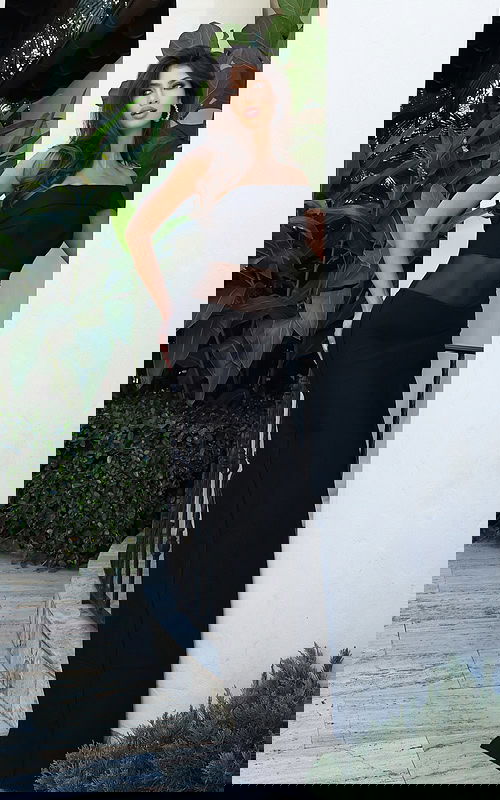 Jovani 51666 black off the shoulder fitted bandage gown with sheer mesh midriff cutout and floor length column silhouette