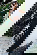 Jovani 51666 black off the shoulder bandage dress close up showing folded neckline detail, sheer mesh waist panel, and structured bodice