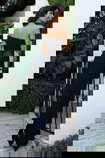 Jovani 51666 black off the shoulder fitted bandage gown back view showing folded neckline, sheer mesh waist panel, zipper closure, and floor length column silhouette