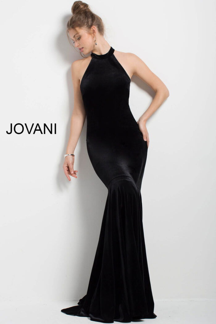 model wearing Jovani 51680 black velvet mermaid gown with halter neckline