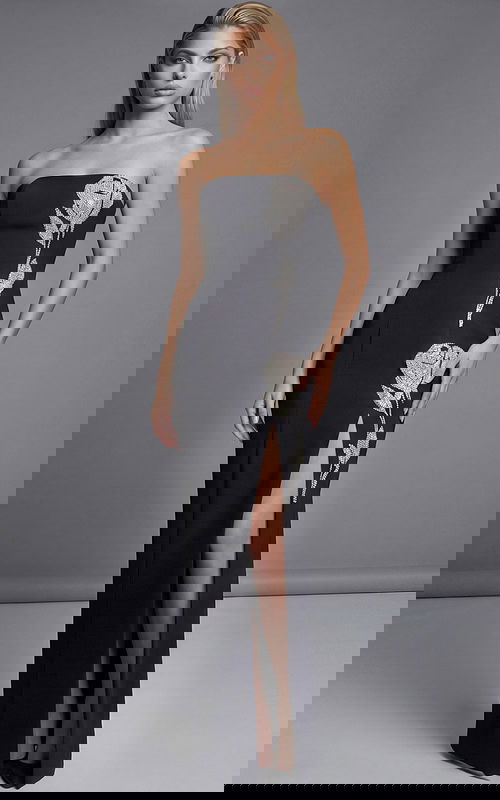 Strapless black evening gown with crystal floral embellishment and thigh high slit