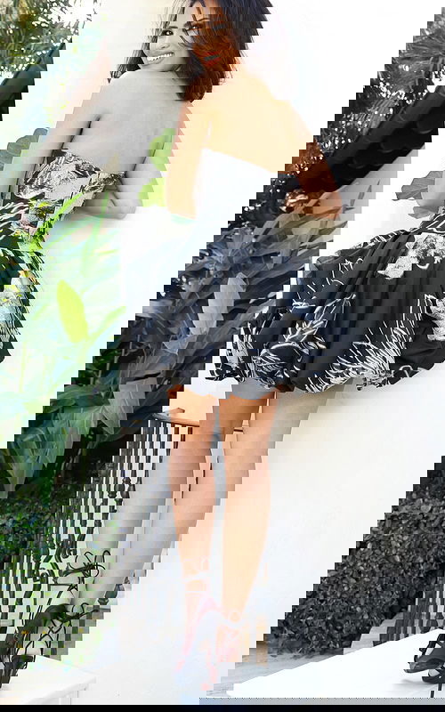 Strapless bubble hem mini dress with structured bodice and abstract print