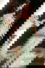 Close up of fitted green gown with intricate crystal bead pattern and sweetheart neckline