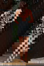 Jovani 52449 black and silver short dress back view showing open back with lace up tie closure, crystal embellished spaghetti straps, and beaded bow motif grid pattern