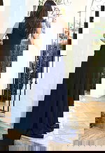 Jovani 53168 navy sleeveless jumpsuit back view showing clean fitted bodice with floral applique detail at the side and wide leg pants with sweep train