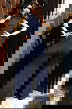 Jovani 53168 navy sleeveless high neck jumpsuit with 3D floral applique detailing at the neckline and waist, and wide leg pants