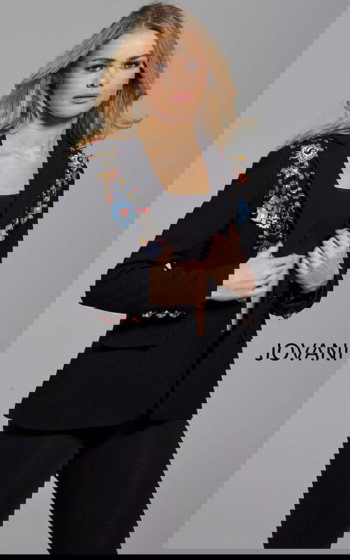 Model wearing Jovani M55213 black blazer with floral embellishments, front view