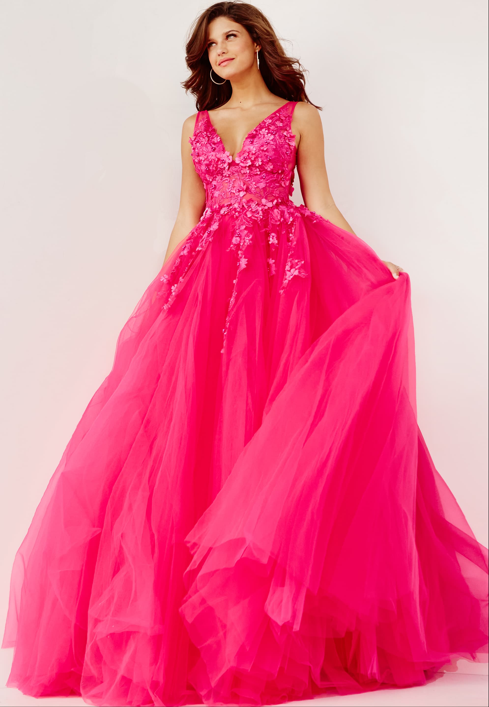 55634-FUCHSIA-ballgown.jpg Model wearing Jovani 55634 fuchsia ball gown with V-neckline and lace appliques.