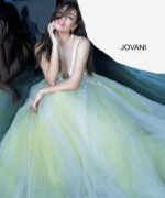 model wearing Jovani 55634 gown with yellow accents and lace applique