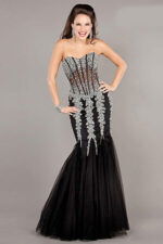 Model wearing Jovani 5908 black gown with embellishments and sweetheart neckline.