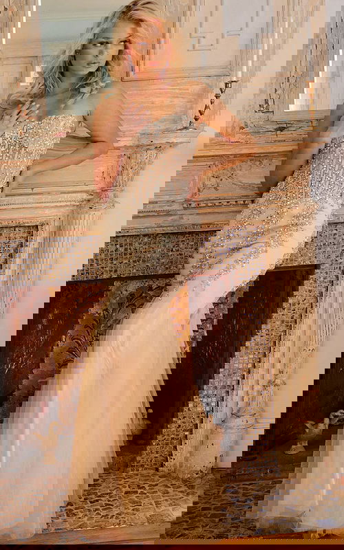 Model in Jovani 5908 beige mermaid dress with beading.