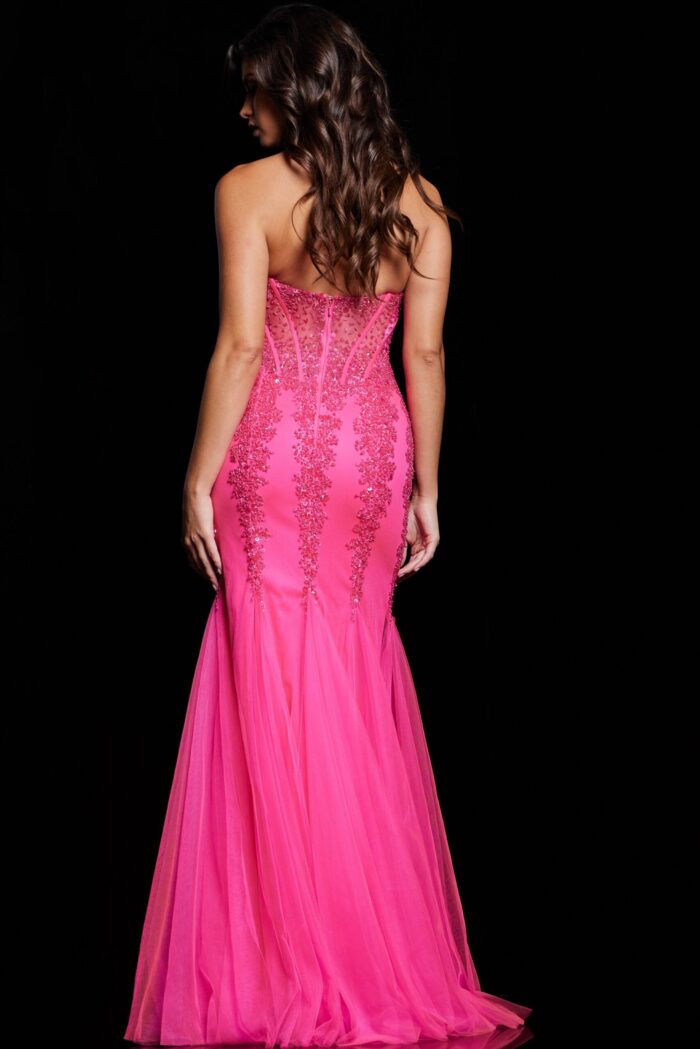Back view of model wearing Jovani 5908 pink mermaid gown showcasing the embellishments.