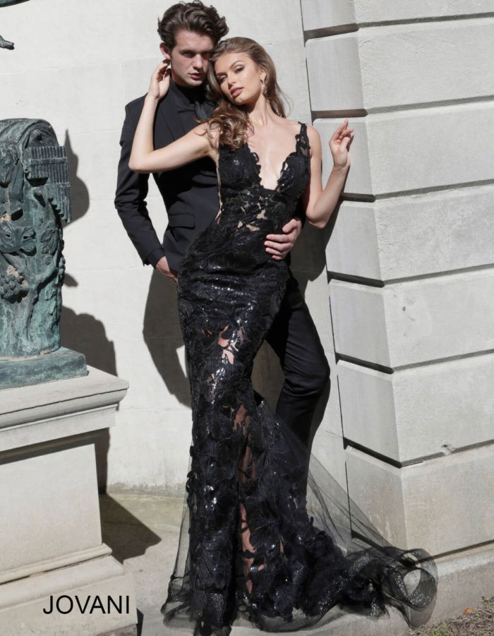 Models in Jovani 60283 in black and red, showing lace detail.