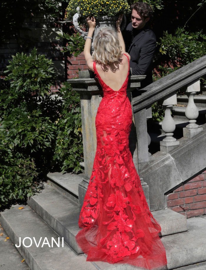 Model wearing Jovani 60283 in red, showcasing lace back.