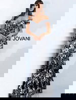 Model wearing Jovani 61380 black dress with off-shoulder neckline and floral embroidery, front view.