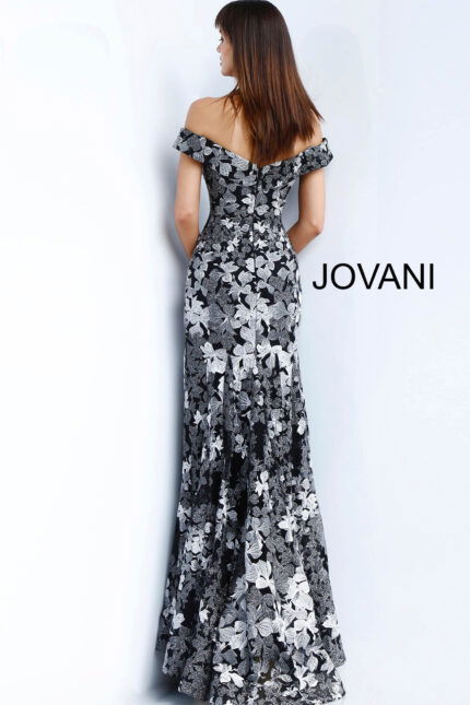 Model wearing Jovani 61380 black dress with off-shoulder neckline and floral embroidery, full front view.