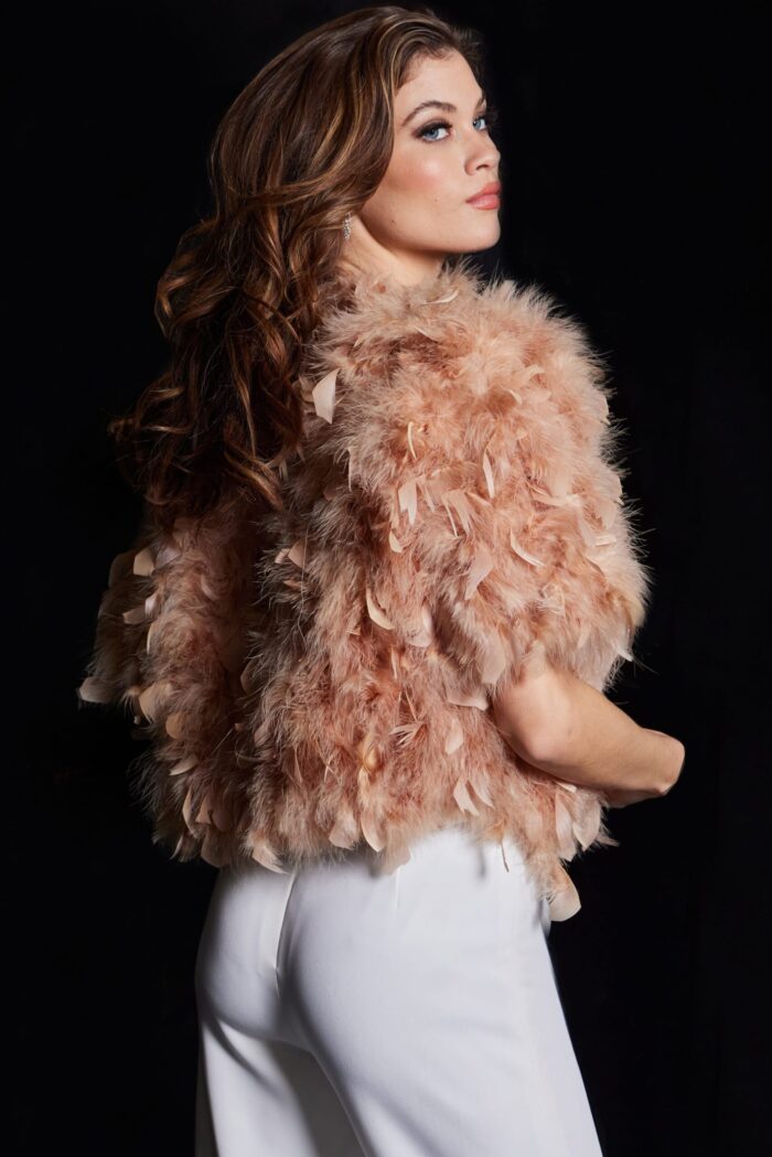 Model in Jovani 62104 nude dress, back view highlighting feather details.