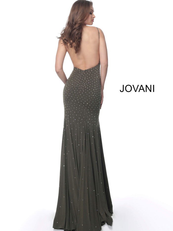 Model showcasing the back of Jovani 63563 green gown with open back design