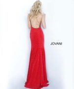 Model showcasing the back of Jovani 63563 red gown with elegant design