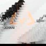 Back view of model in Jovani 63987 dress with floral details.