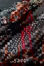 Model wearing Jovani 79121 black floor-length gown with shimmering texture.