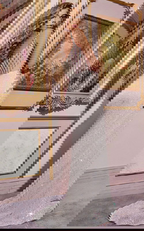 Model showing back view of Jovani D5601 white gown with scoop back and embellishments.