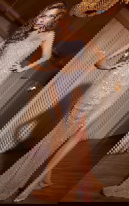 Model wearing Jovani D5608, a nude gown with a full-length silhouette and intricate beadwork, front view.