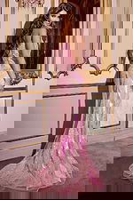 Model showing the back of Jovani D5715 pink dress with intricate beading.