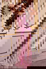 Model wearing Jovani D5715 pink dress highlighting the front design and high slit.