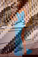 Model wearing Jovani D5715 blue dress with a high slit and sweetheart neckline.