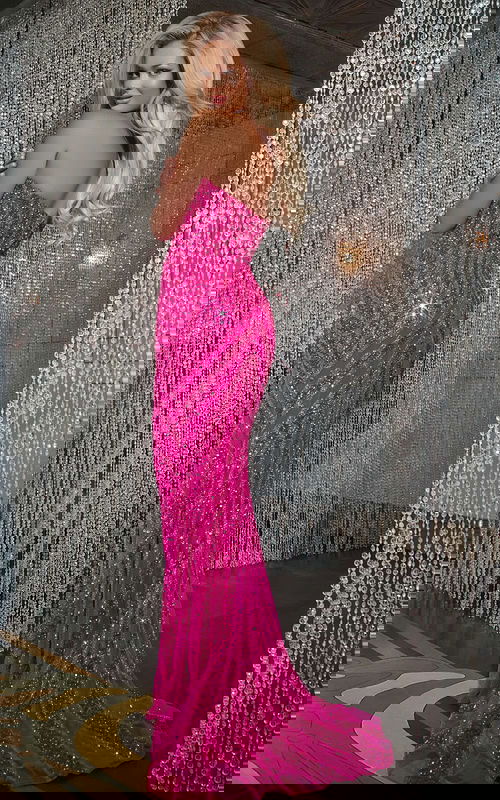 Back view of model wearing Jovani D5724 fuchsia gown, showcasing flowing sequined fabric.