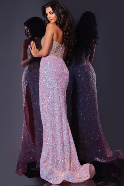 Back view of model in Jovani D5742 pink gown showing detailed beaded back.
