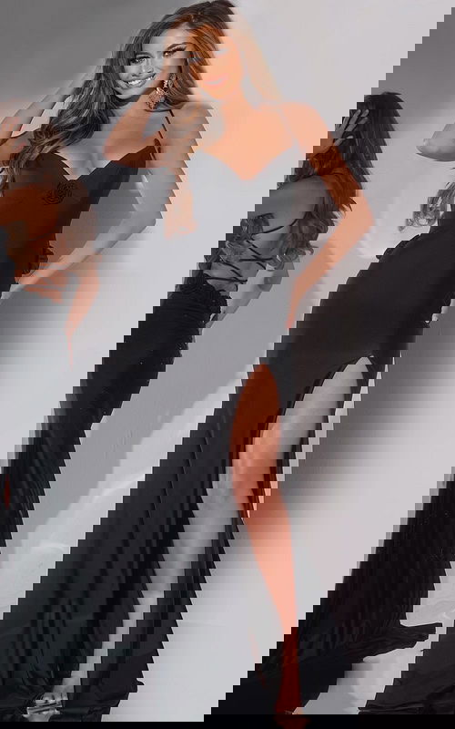 Model wearing Jovani D5821 black dress with V-neckline and high slit.