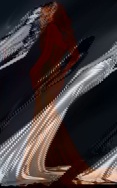 Back view of Jovani D5903 gold gown featuring lace-up design and mermaid silhouette.