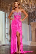 Model wearing Jovani D6031 pink gown with strapless neckline and high slit