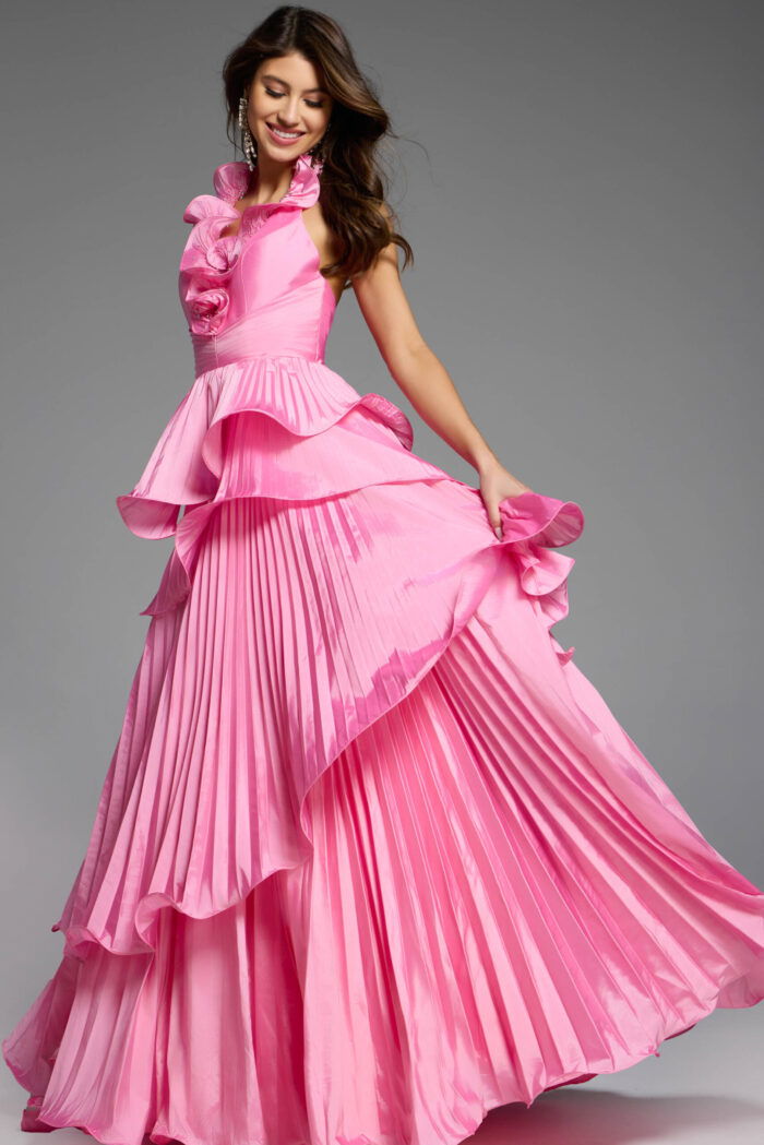 Elegant pink pleated gown with tiered ruffles and halter neckline.