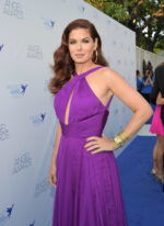 model wearing Jovani 50612 purple gown with a twisted halter neckline.