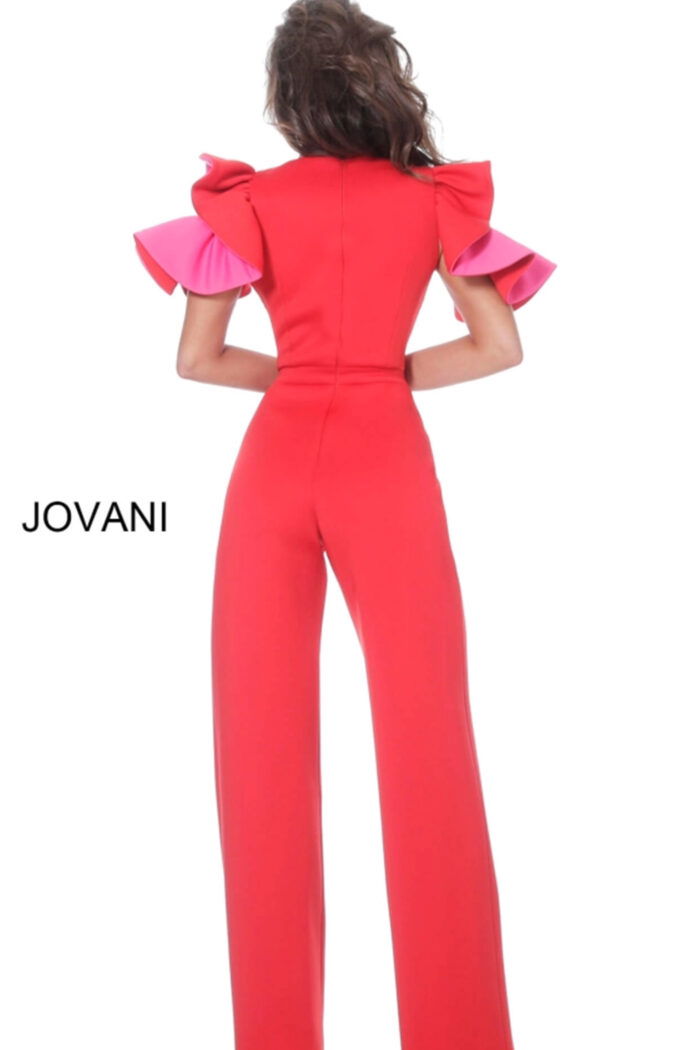 Model wearing Jovani 68736 red jumpsuit with pink ruffled sleeves, back view.