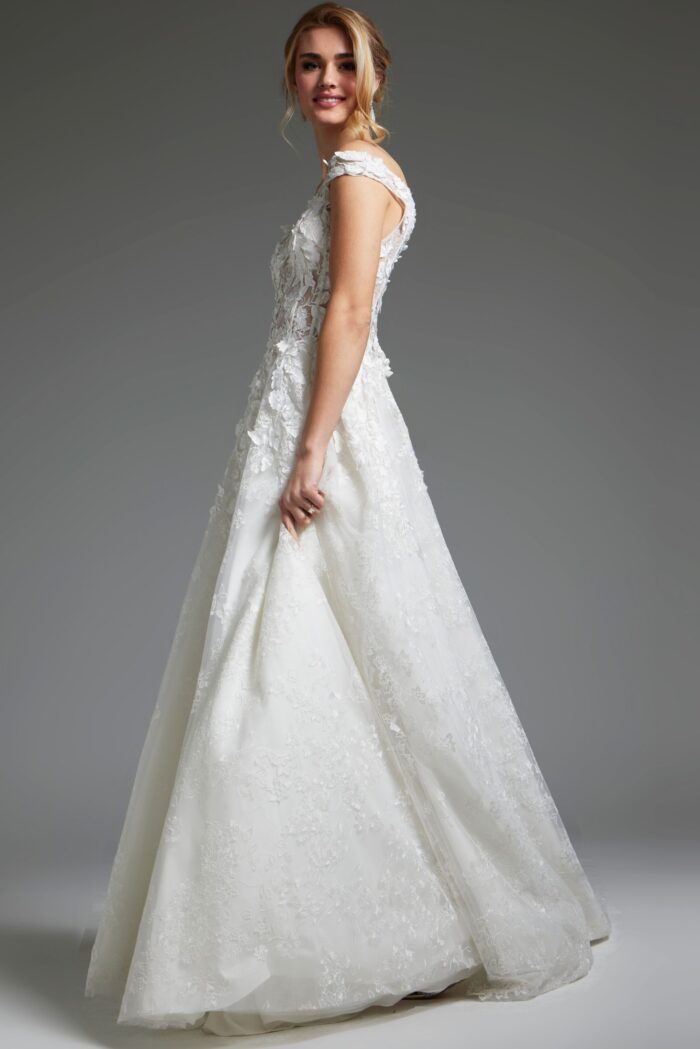 Model wearing Jovani JB05402 shows side view of off-the-shoulder white dress.