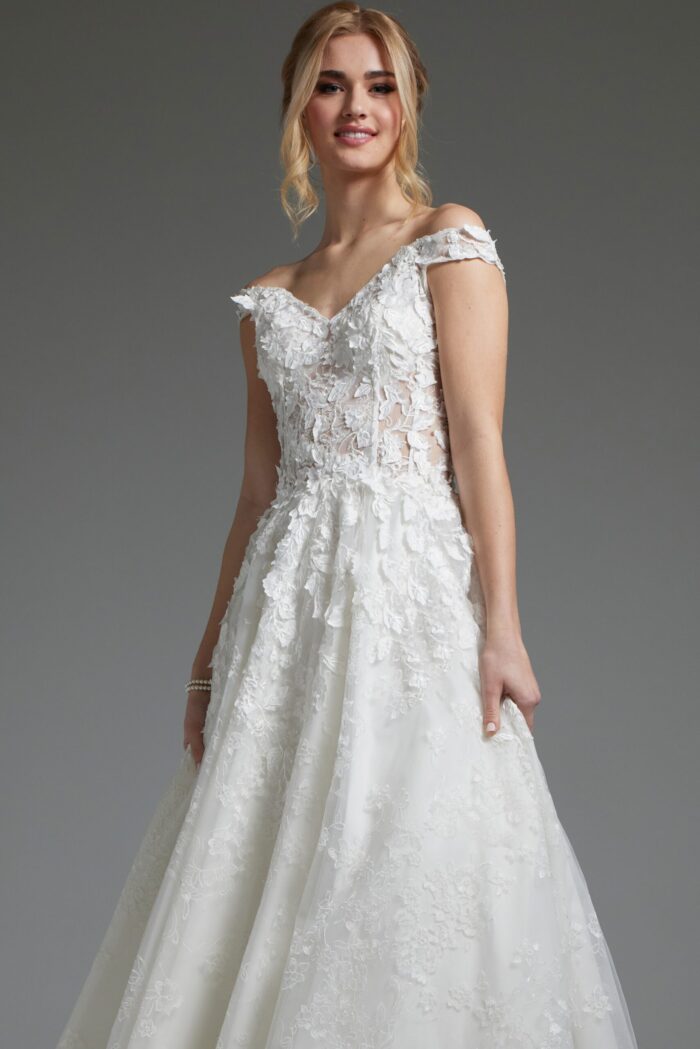 Model wearing Jovani JB05402 highlights off-the-shoulder white dress detail.