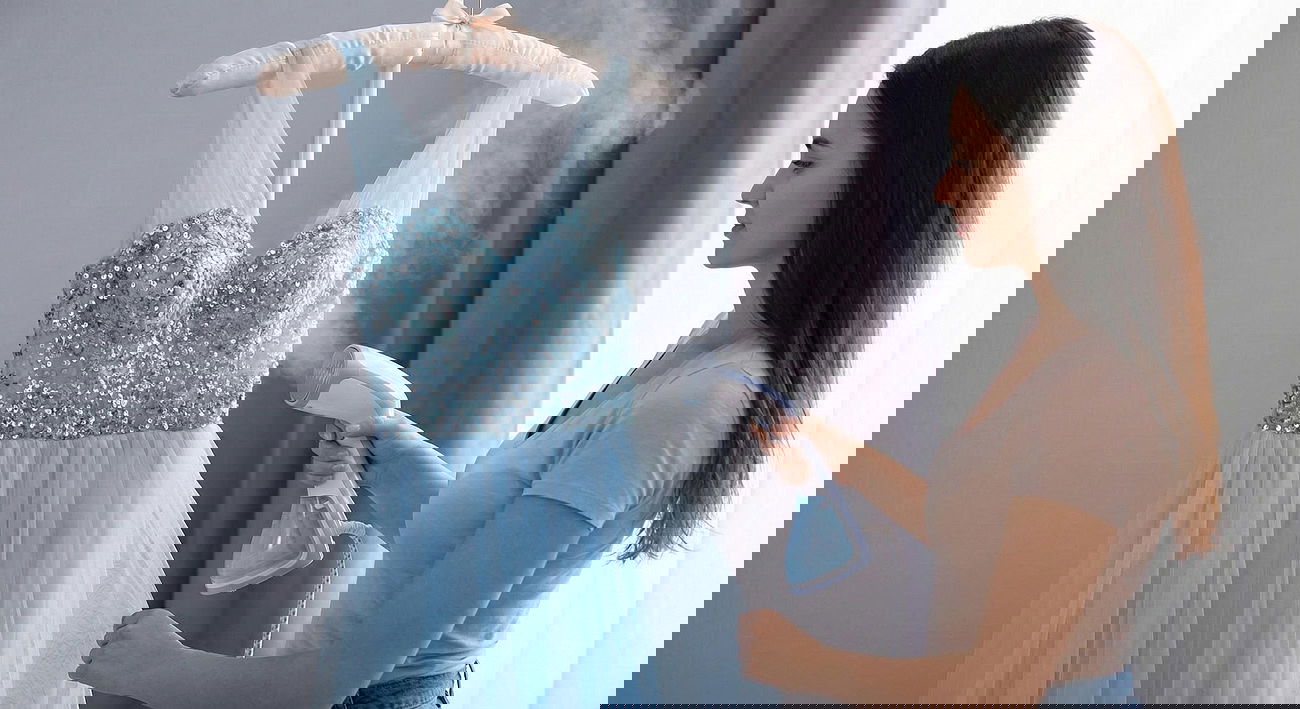 Steaming a dress with a handheld steamer