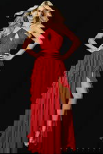 Front view of red halter gown with ruffled slit and flowing skirt