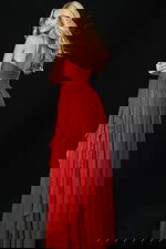 Back view of red gown with open back and layered ruffle train